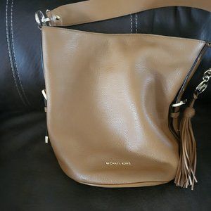 Michael Kors Bucket Bag fringe (MK log) on side . Great condition